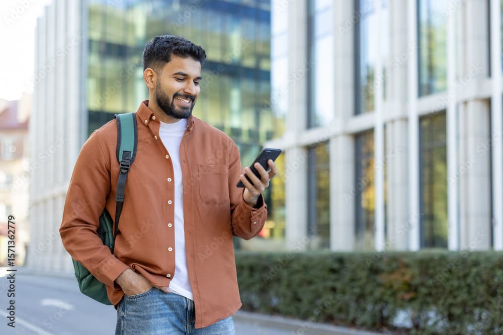 A graduate walking past a modern building while exploring career opportunities